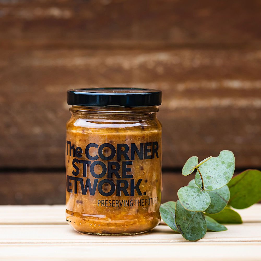 jar of chutney sitting on timber box next to foliage