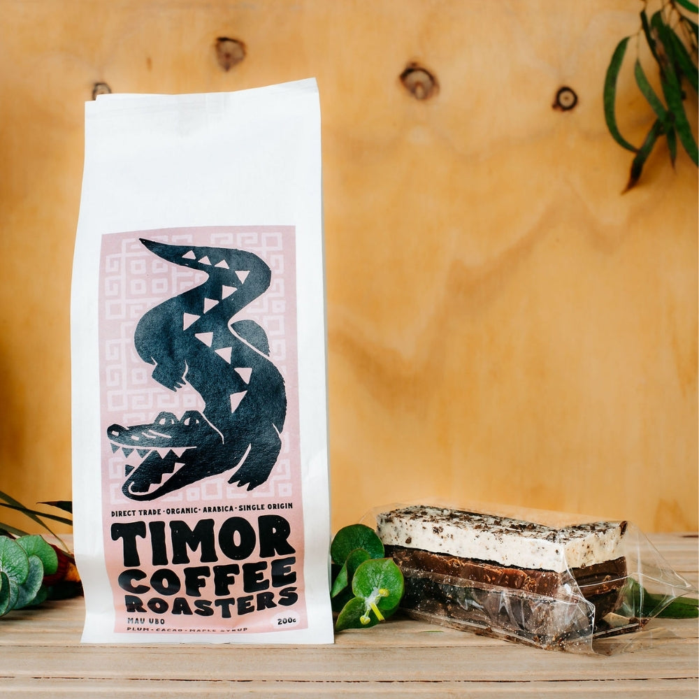 Timor Coffee Roasters coffee bag with a decorative design on a wooden surface.