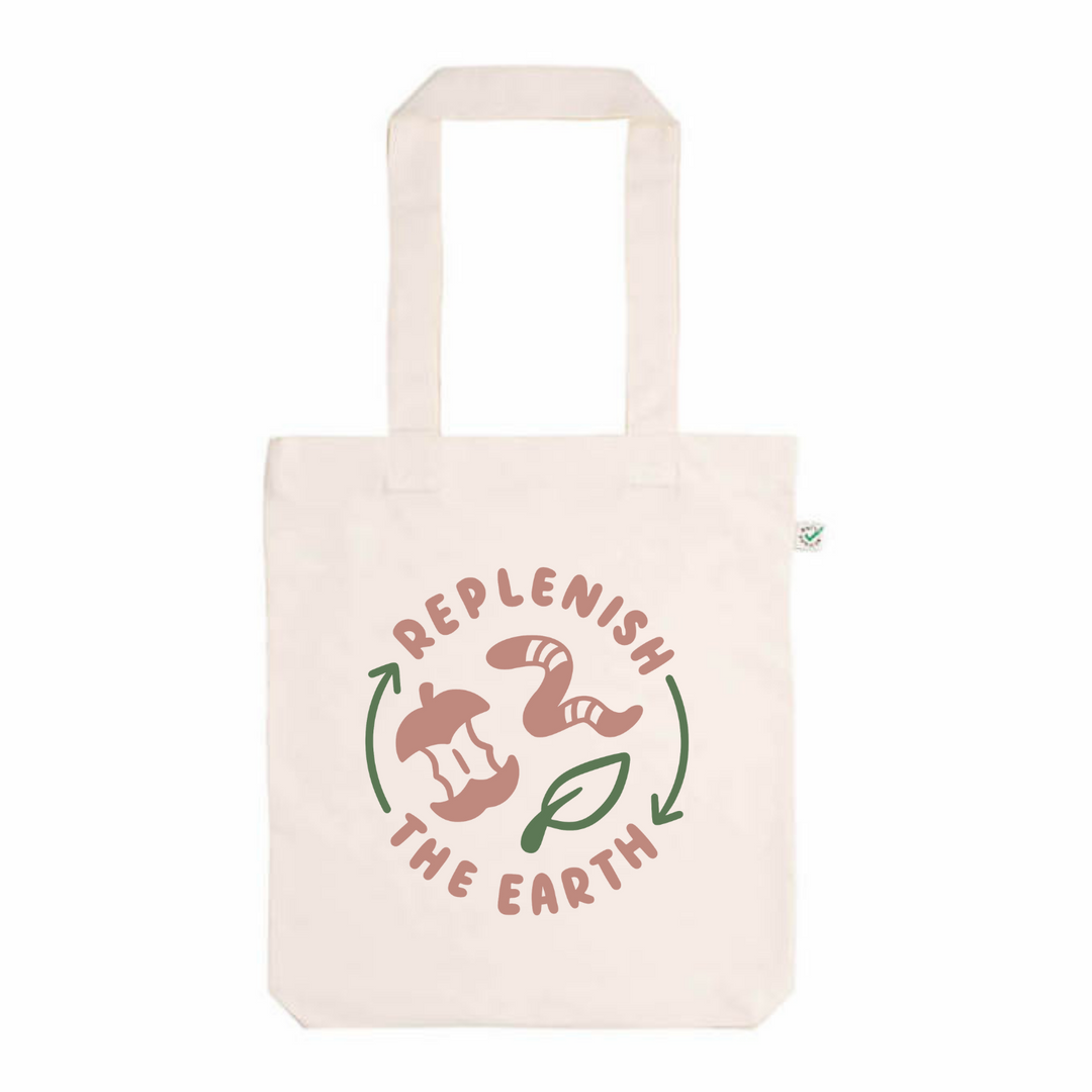 organic white cotton tote with pink and green design saying replenish the earth with apple, worm and leaf