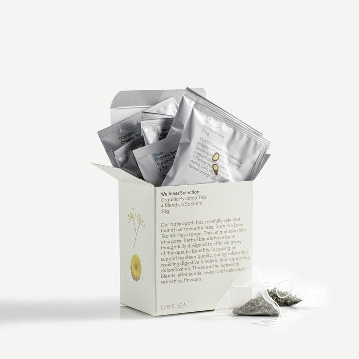 love tea sampler box with individually wrapped organic wellness tea bags sticking out the top