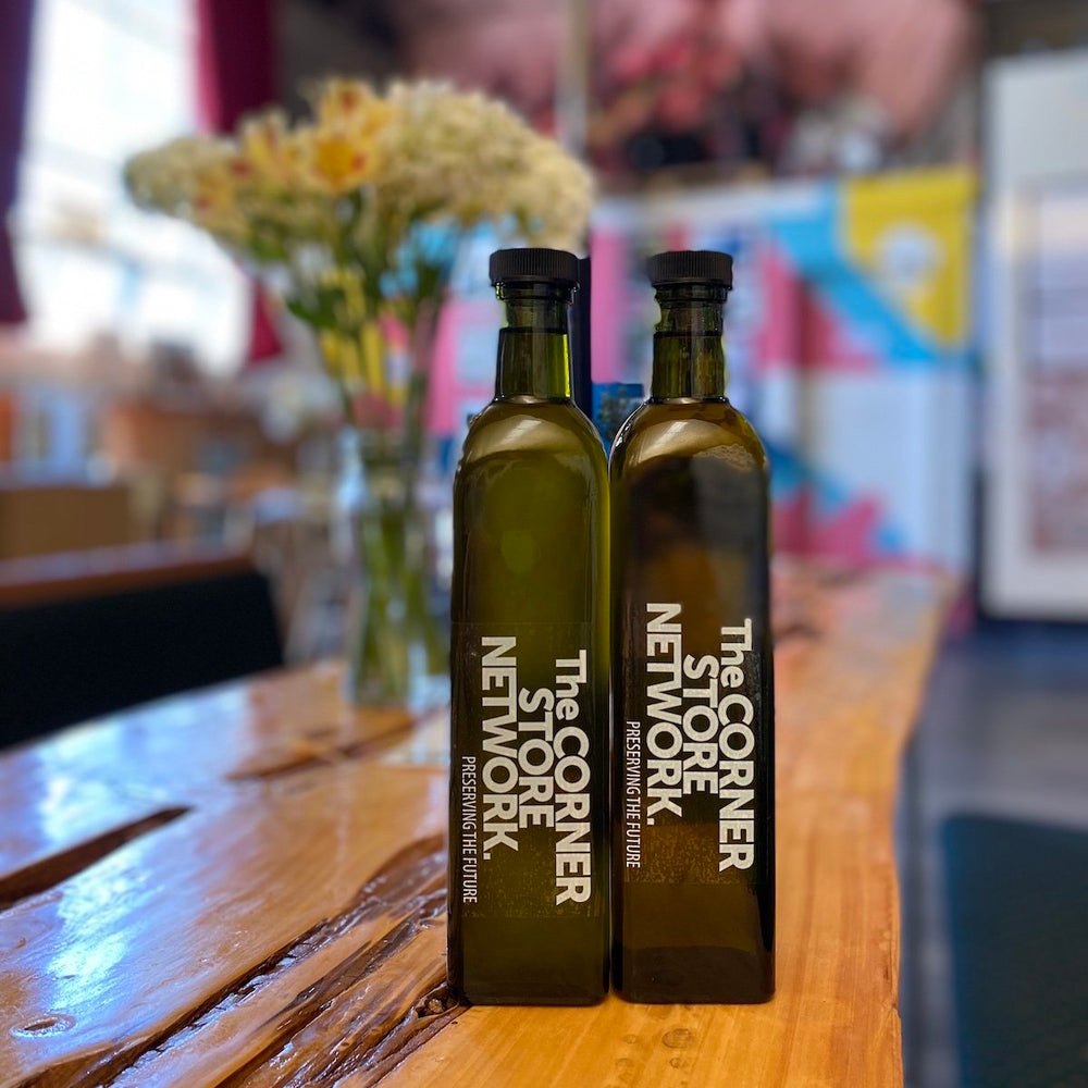 two bottles of melbourne made olive oils on timber table